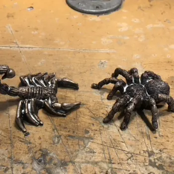 Dark metal castings of a scorpion and a spider