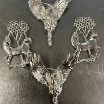 Silver castings of winged figures and deer