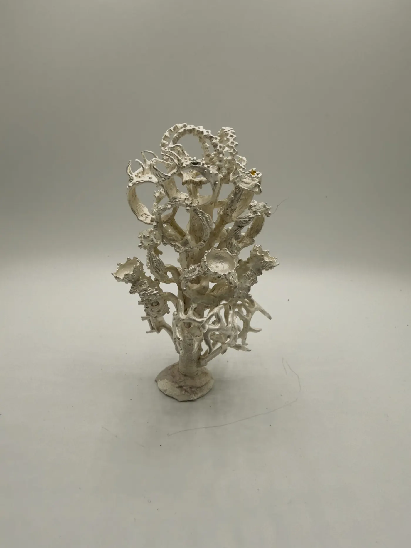 A cast silver tree of ornate pieces still joined at the sprue